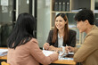 © aekachai - Asian business presents to explain the graph work on the whiteboard. Consulting, discussing, exchanging knowledge.