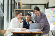 © aekachai - Asian business presents to explain the graph work on the whiteboard. Consulting, discussing, exchanging knowledge.