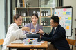 © aekachai - Asian business presents to explain the graph work on the whiteboard. Consulting, discussing, exchanging knowledge.
