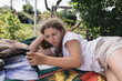 preteen girl relaxing in summer garden, country life in germany