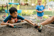 © Cavan - Mother giving son a cucumber seedling to plant in backyard garden