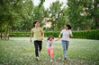 © boytsov - Smiling Family Running Across Summer Field Together. Mother Daughter son, hands together High quality photo