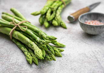 Bunch of raw asparagus stems with different spices