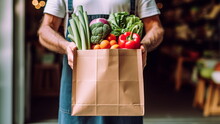 Delivery Concept. A Man Holding A Box Of Vegetables To Be Delivered To A Customer. Online Market,internet Supermarket And Orders. Grocery Home Delivery.