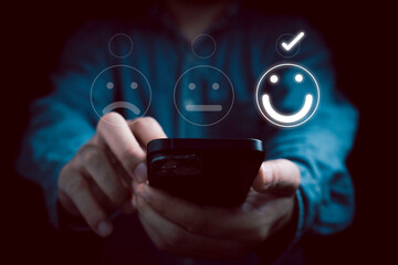 Poster - Businessman using smartphone to select  smile face for the best evaluation from client , customer satisfaction concept.