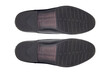 footprints, classic men's black leather shoes bottom view isolated from background