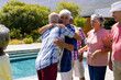 © WavebreakMediaMicro - Happy senior diverse people having party and embracing in garden