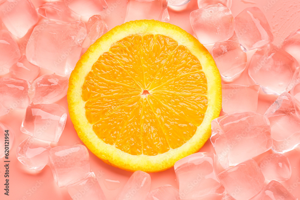 Orange slice with ice cubes on pink background
