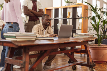 Wall Mural - modern coworking african man with laptop