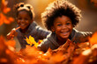 canvas print picture - black kids playing in autumn leaves on a sunny day