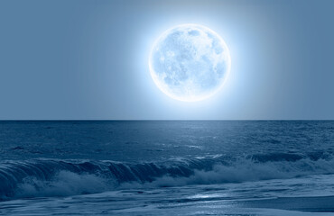 Wall Mural - Night sky with blue moon over the calm blue sea 