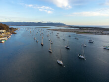 Aerial View Of Boats Of Morro Bay Aligned By The Tide In The Late Afternoon Sun. 
