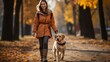 woman walking with her dog in autumn  park 