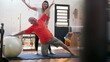 Pilates instructor guiding senior man to exercise with ball. Older person strengthening body and gaining flexibility