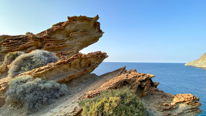 Wall Mural - Calm Gokceada (Yildizkoy-Blue bay ) landscape with sea to the skyline, and a craggy outcrop of rocks to the left. Gokceada, Imbros island, Turkey