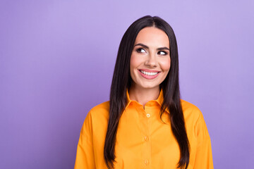 Sticker - Photo of thoughtful smart business woman wearing orange shirt smiling look empty space brainstorming isolated on purple color background