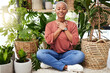 © Lategan/peopleimages.com - Peace, breathe and calm woman by plants for meditation exercise in a greenery nursery. Health, gratitude and young African female person with a relaxing zen mindset by an indoor greenhouse garden.