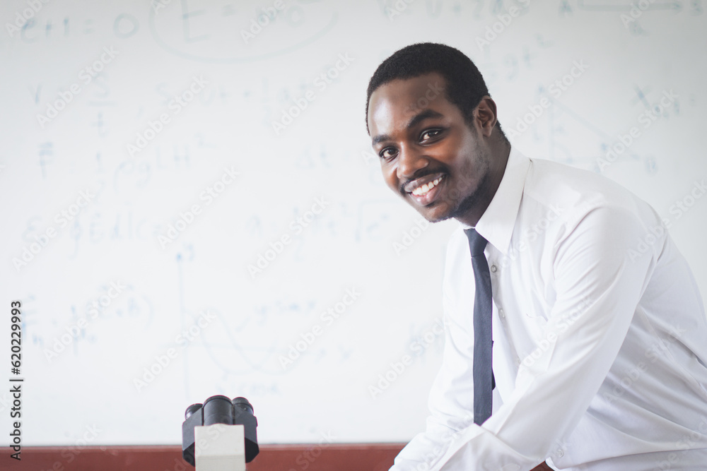 Smile african teacher in white shirt is experimenting and explaining a ...