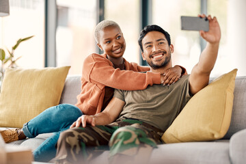 Home, selfie and couple on a couch, love and happiness with romance, relationship and marriage. Social media, black woman and Asian man on a sofa, romantic and memory with profile picture and relax