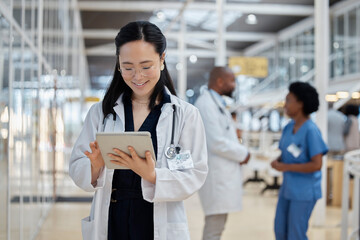 Canvas Print - Doctor, asian woman and tablet for medical planning, data research and healthcare app in busy hospital. Happy female therapist, digital technology and consulting information for telehealth in clinic