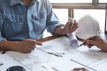Fototapete - Architects interior designer hands working with Blue prints and documents for a home renovation for house design