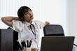 © Jack Tamrong - Young working woman sitting in office and feeling tired after working hard
