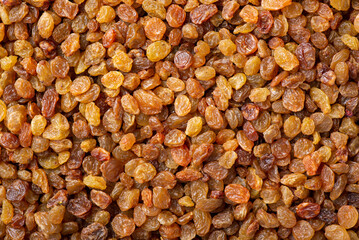 Canvas Print - Flat lay background of raisins. Tasty sweet raisins made of high-quality grape