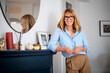 © sepy - Blond haired middle aged woman wearing casual clothes and relaxing at home