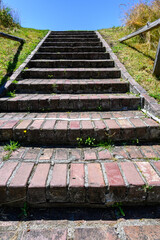 Wall Mural - Weathered brick stairs leading up to a blue summer sky
