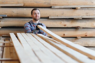 Wall Mural - Joiner in uniform check boards on timber mill