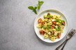 Pasta salad. Traditional Italian pasta with cherry tomatoes, olives, feta cheese, green lettuce