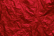 Red crumpled texture background. Abstract banner with shine red.  Flat lay mockup design. Craft paper texture sheet abstract background, wrapping texture.