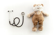 Kids medical checkup and health concept with stethoscope and teddy bear