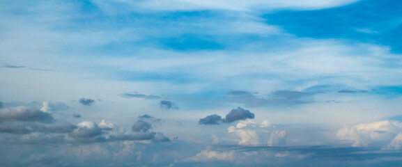 Wall Mural - Blue sky with low puffy clouds shot at 50 mm focal length