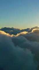 Wall Mural - flying above the clouds. aerial view of clouds and morning sun. traveling by air perfect background.