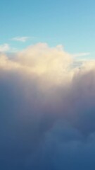 Wall Mural - flying above the clouds. aerial view of clouds at sunrise. traveling by air perfect background. vert