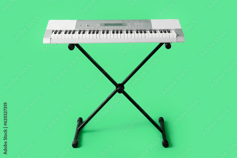 Modern synthesizer on green background
