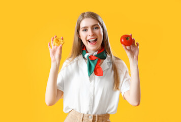 Wall Mural - Young woman with raw pasta and tomato on yellow background