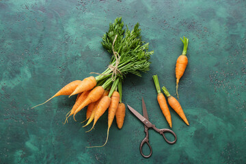 Many fresh carrots on green background