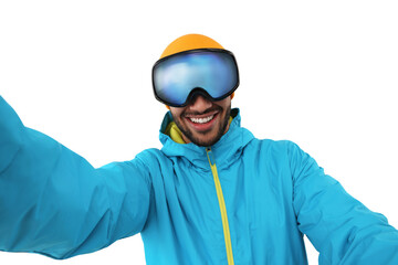 Wall Mural - Smiling young man in ski goggles taking selfie on white background