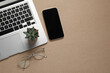 © New Africa - Modern laptop, houseplant, glasses and smartphone on beige table, flat lay. Space for text