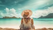© GnrlyXYZ - Woman in a straw hat sitting on a tropical beach. Girl looking at turquoise water.