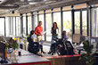 © Wavebreak Media - Diverse business people having meeting, discussing work and using laptop and tablet at office