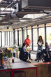 © Wavebreak Media - Diverse business people having meeting, discussing work and using laptop and tablet at office