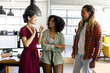 © Wavebreak Media - Three happy diverse casual business colleagues standing in sunny office talking