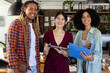 © Wavebreak Media - Portrait of happy diverse casual business colleagues standing in sunny office with tablet and folder