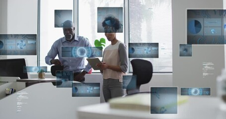 Canvas Print - Animation of data processing against african american man and woman discussing at office