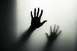 © photobuay - Mystical Shadows Defocused Hand Silhouette behind Frosted Glass, Evoking Halloween Concept in Black and White Mode. created with Generative AI