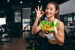 © Quality Stock Arts - sport healthy beautiful asian woman showing vegetables mix salad for diet food low calories in fitness sport club