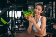 © Quality Stock Arts - sport healthy beautiful asian woman showing vegetables mix salad for diet food low calories in fitness sport club